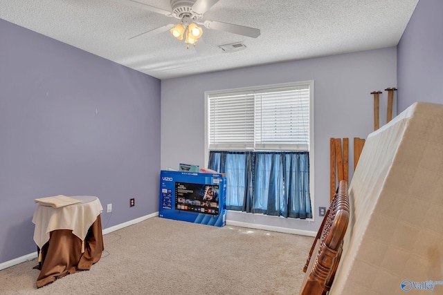 rec room with carpet floors, baseboards, a ceiling fan, and a textured ceiling