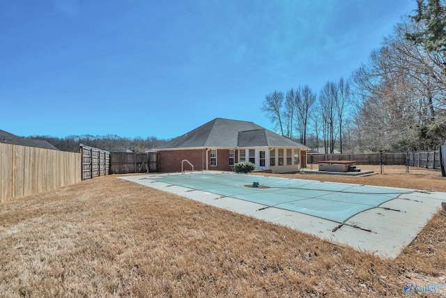 view of swimming pool featuring a patio area, a fenced backyard, a fenced in pool, and a hot tub