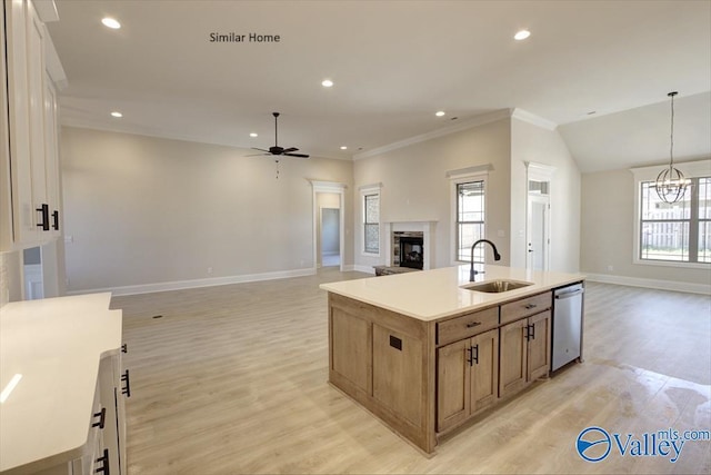 kitchen featuring decorative light fixtures, sink, a kitchen island with sink, stainless steel dishwasher, and light wood-type flooring