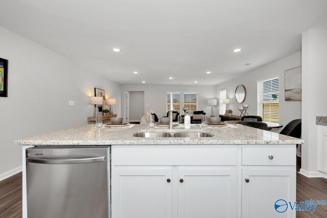 kitchen with sink, stainless steel dishwasher, white cabinets, and light stone countertops