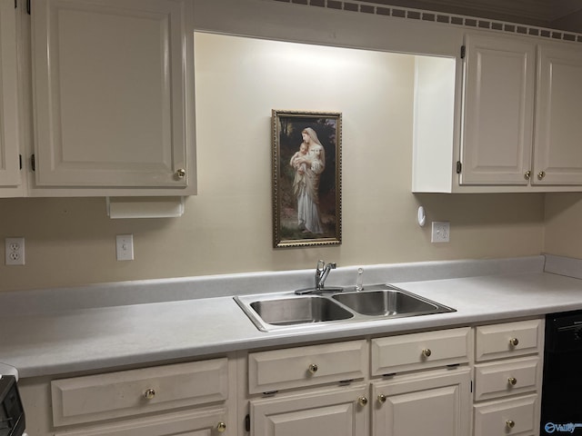 kitchen with dishwasher, light countertops, a sink, and white cabinets