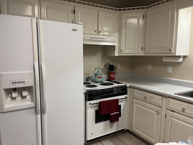 kitchen featuring white appliances, light countertops, under cabinet range hood, white cabinetry, and light tile patterned flooring