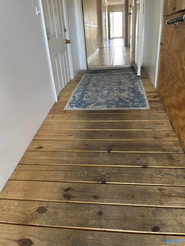 corridor featuring wood-type flooring