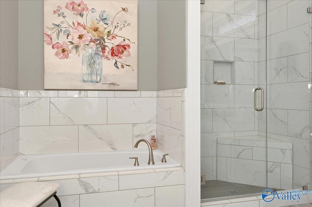 bathroom with a shower stall and a bath