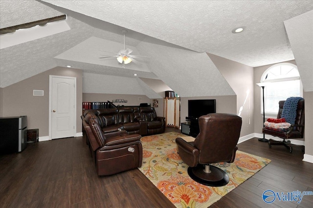 living area featuring ceiling fan, wood finished floors, baseboards, a textured ceiling, and lofted ceiling