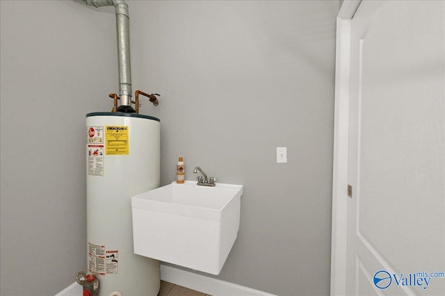 utilities featuring gas water heater and a sink