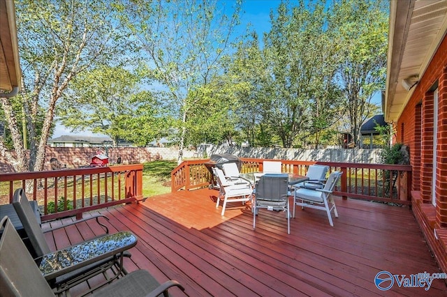 wooden deck featuring a fenced backyard and outdoor dining area