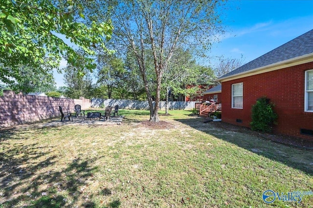 view of yard with an outdoor fire pit and a fenced backyard