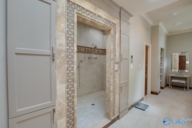 bathroom with tiled shower, ornamental molding, and tile patterned floors