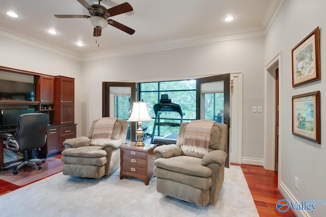 office area featuring ornamental molding, light hardwood / wood-style flooring, and ceiling fan