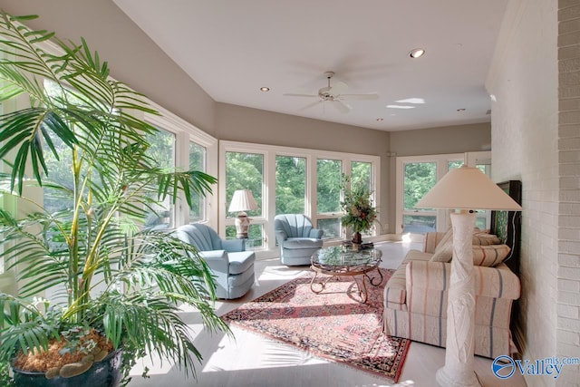 sunroom / solarium featuring ceiling fan