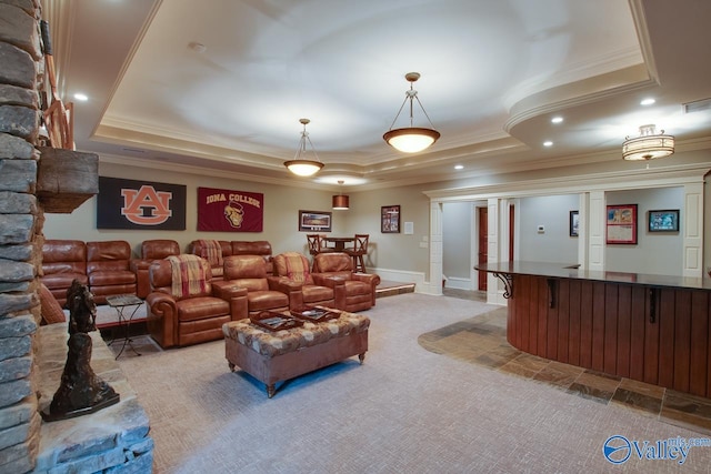 carpeted living room featuring a tray ceiling and ornamental molding