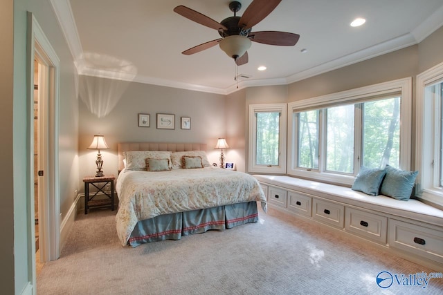 bedroom featuring ornamental molding, light carpet, and ceiling fan