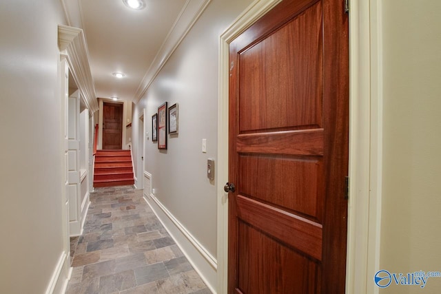 hallway with tile patterned floors and crown molding