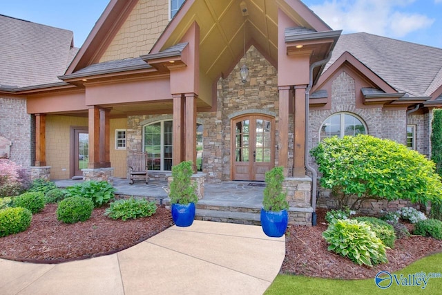2833 High Mountain Rd NE, Huntsville, AL 35811 - entrance to property featuring roof with shingles, covered porch, and stone siding