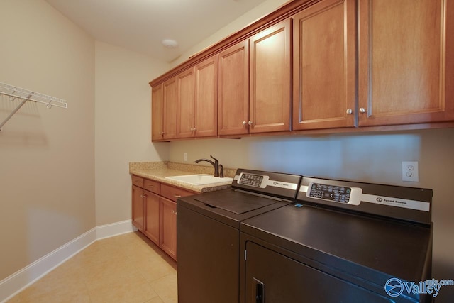 2833 High Mountain Rd NE, Huntsville, AL 35811 - clothes washing area featuring washing machine and dryer, cabinet space, a sink, baseboards, and light tile patterned floors
