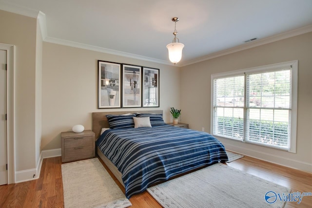 2833 High Mountain Rd NE, Huntsville, AL 35811 - bedroom featuring baseboards, visible vents, ornamental molding, and wood finished floors
