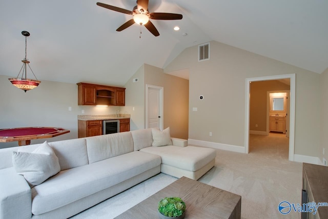 2833 High Mountain Rd NE, Huntsville, AL 35811 - living area with visible vents, a ceiling fan, baseboards, wine cooler, and vaulted ceiling