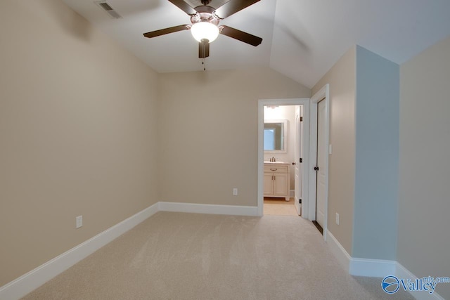 2833 High Mountain Rd NE, Huntsville, AL 35811 - unfurnished bedroom with light carpet, ensuite bath, baseboards, lofted ceiling, and visible vents
