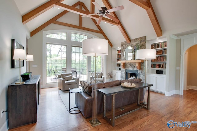2833 High Mountain Rd NE, Huntsville, AL 35811 - living area featuring beamed ceiling, high vaulted ceiling, a fireplace, and a wealth of natural light