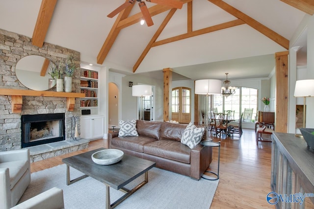 2833 High Mountain Rd NE, Huntsville, AL 35811 - living area with high vaulted ceiling, a stone fireplace, ceiling fan with notable chandelier, and light wood-style floors