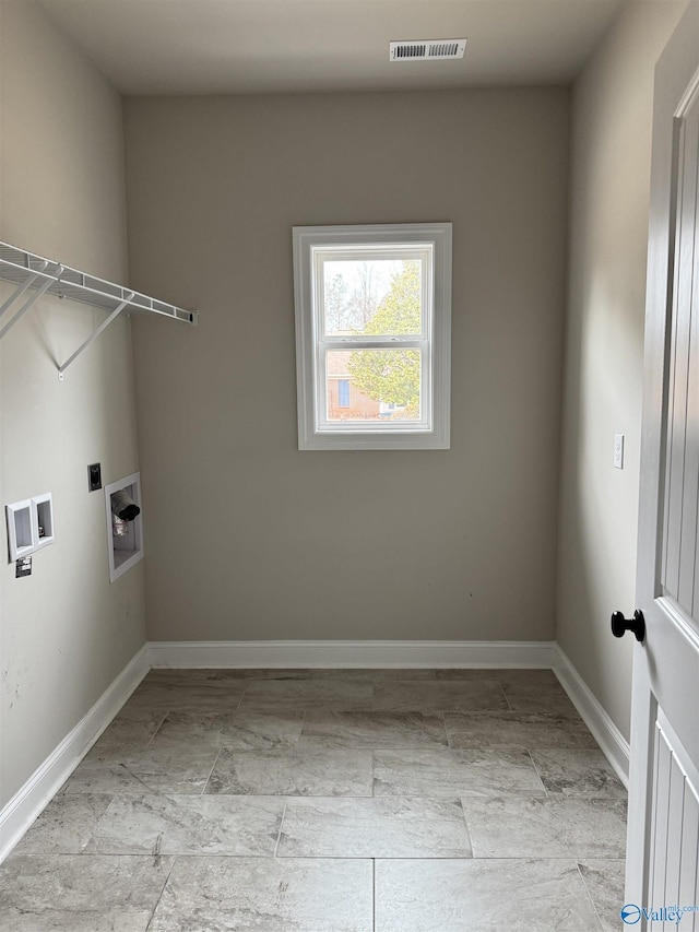 clothes washing area with laundry area, baseboards, visible vents, and washer hookup