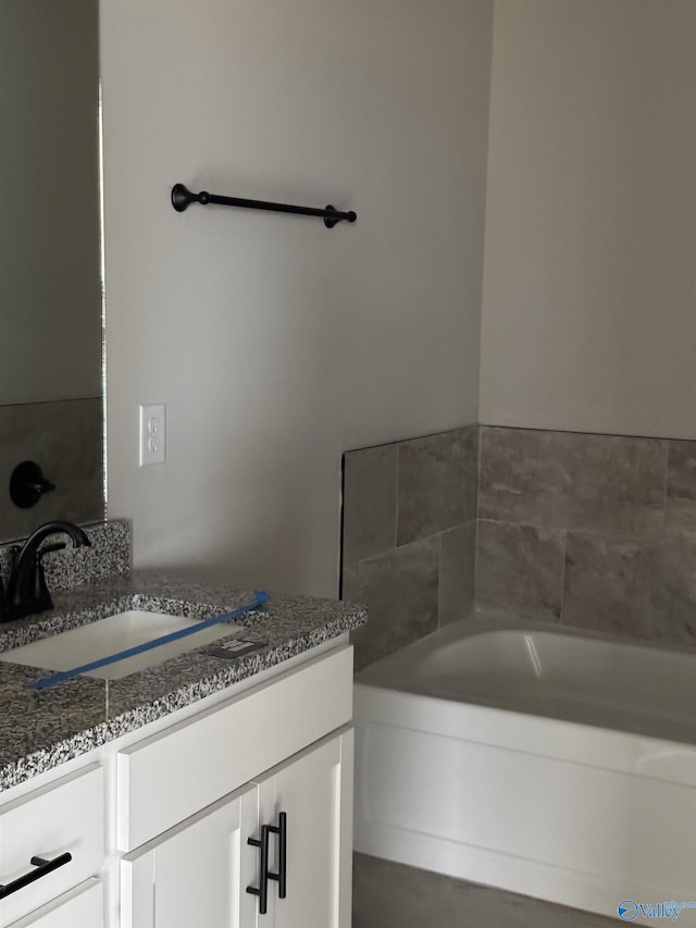 bathroom with a bath and vanity