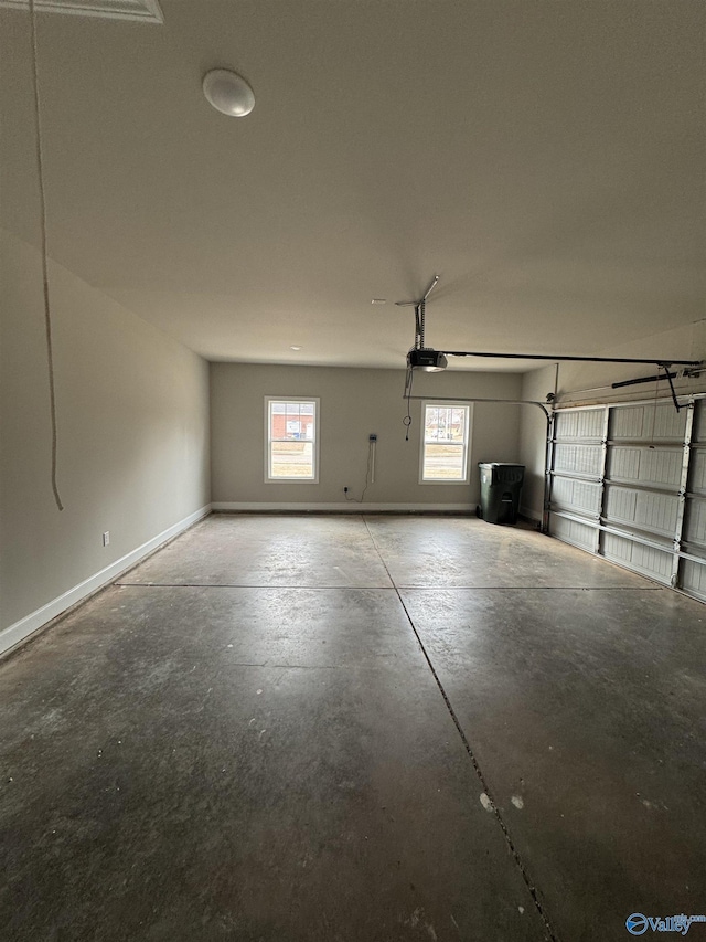 garage with baseboards and a garage door opener