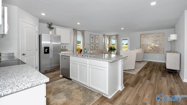 403 Jackson Point Cir, Huntsville, AL 35811 - kitchen featuring appliances with stainless steel finishes, dark wood finished floors, white cabinets, an island with sink, and recessed lighting
