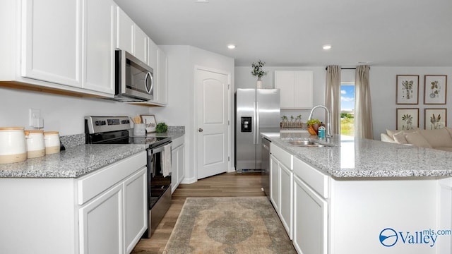 403 Jackson Point Cir, Huntsville, AL 35811 - kitchen featuring appliances with stainless steel finishes, wood finished floors, white cabinetry, a center island with sink, and recessed lighting