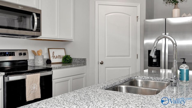 403 Jackson Point Cir, Huntsville, AL 35811 - kitchen featuring stainless steel appliances, white cabinetry, and light stone countertops