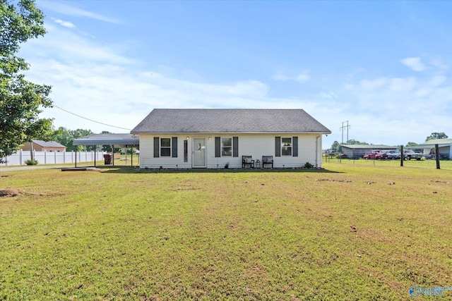 26150 Mooresville Rd, Elkmont, AL 35620 - view of front of house with fence, a carport, and a front lawn