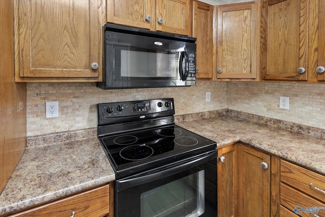 26150 Mooresville Rd, Elkmont, AL 35620 - kitchen with brown cabinetry, backsplash, and black appliances