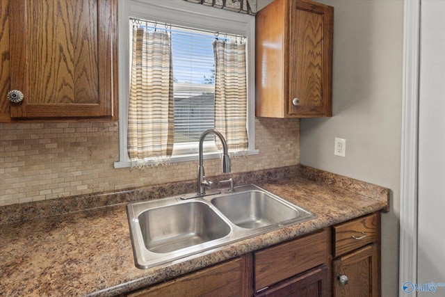 26150 Mooresville Rd, Elkmont, AL 35620 - kitchen with brown cabinets, decorative backsplash, and a sink