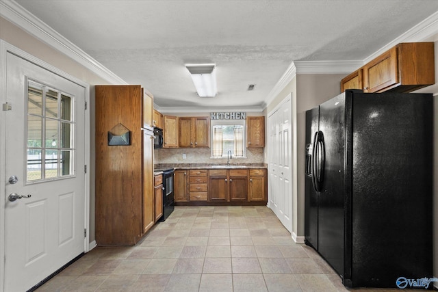26150 Mooresville Rd, Elkmont, AL 35620 - kitchen featuring crown molding, a sink, brown cabinetry, backsplash, and black appliances