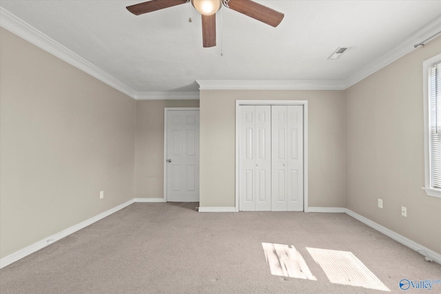 26150 Mooresville Rd, Elkmont, AL 35620 - unfurnished bedroom featuring light carpet, baseboards, visible vents, ornamental molding, and a closet