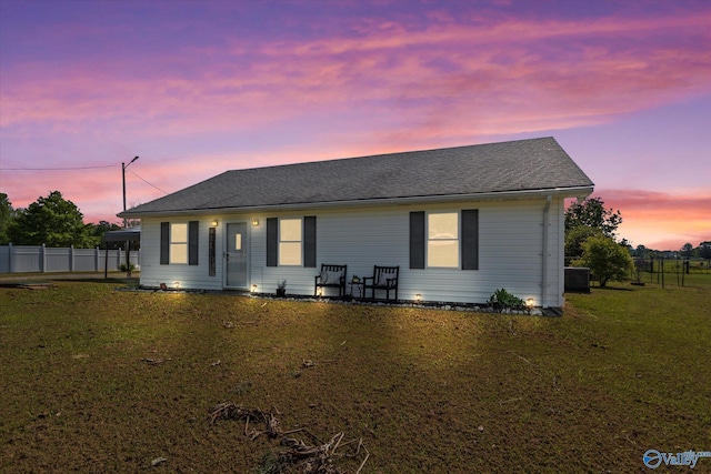 26150 Mooresville Rd, Elkmont, AL 35620 - rear view of house featuring a yard, central AC, fence, and a carport