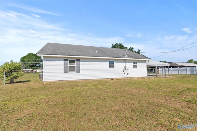 26150 Mooresville Rd, Elkmont, AL 35620 - back of house with fence, a detached carport, and a yard