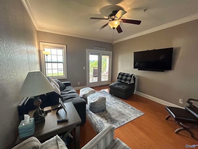 living room featuring ceiling fan, hardwood / wood-style flooring, crown molding, and french doors