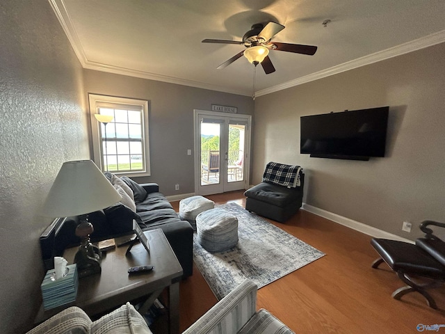 living area with baseboards, french doors, wood finished floors, and crown molding