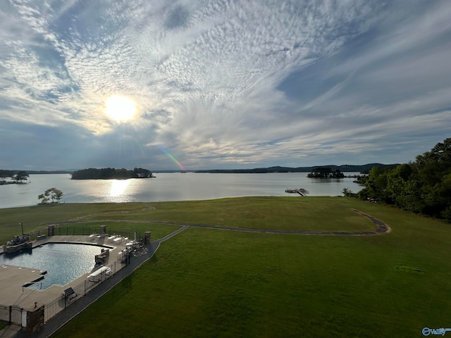 aerial view at dusk featuring a water view