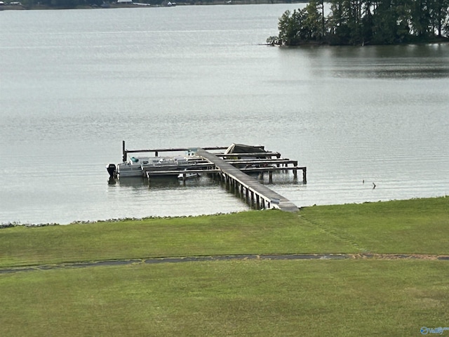 dock area featuring a lawn, a water view, and boat lift