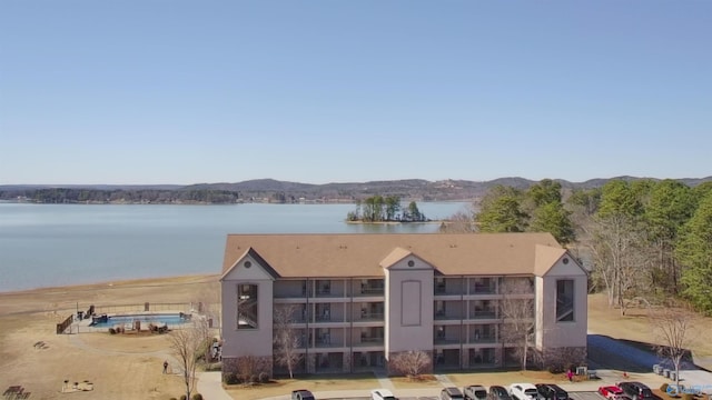 drone / aerial view featuring a water and mountain view