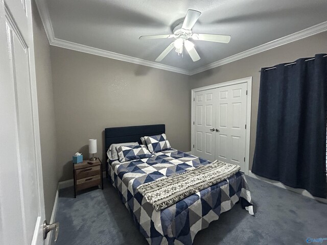 carpeted bedroom featuring ornamental molding, ceiling fan, and a closet