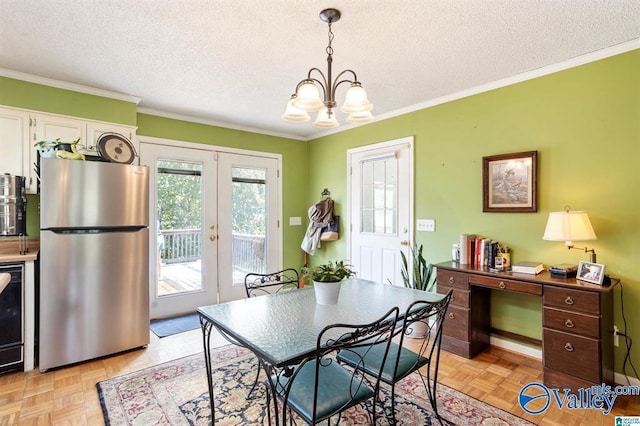 dining space with french doors, crown molding, light parquet floors, a chandelier, and a textured ceiling