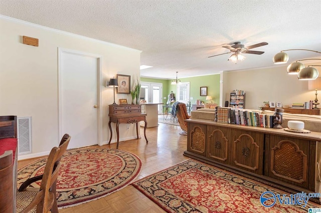 office with a textured ceiling, ceiling fan, and ornamental molding