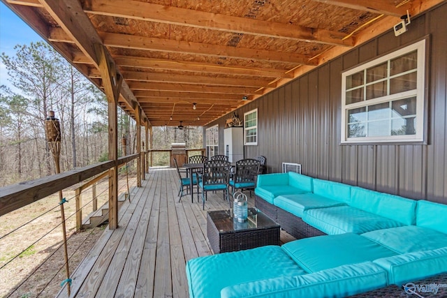 deck featuring an outdoor living space and outdoor dining space