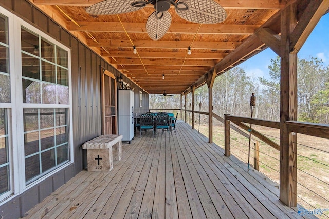 wooden deck featuring a ceiling fan and outdoor dining area
