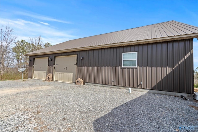 view of side of property with metal roof and an outdoor structure