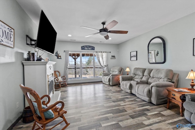 living area with ceiling fan, a fireplace, wood finished floors, and recessed lighting